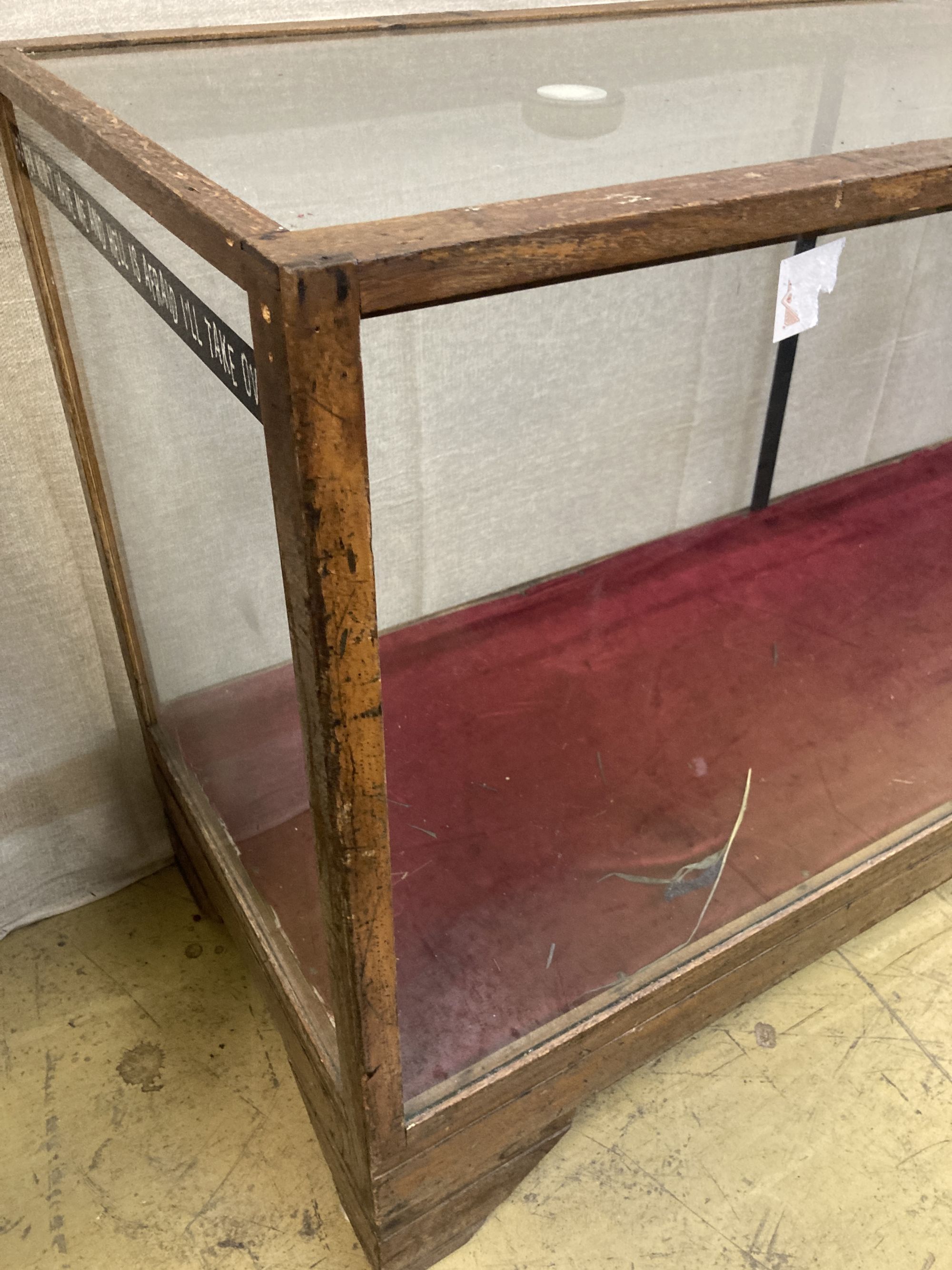 A glazed oak shop display case, length 178cm, depth 58cm, height 92cm (requires two new glass panels)